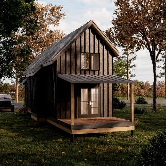 Board-and-batten backyard cottage with a covered porch on a wooded lot